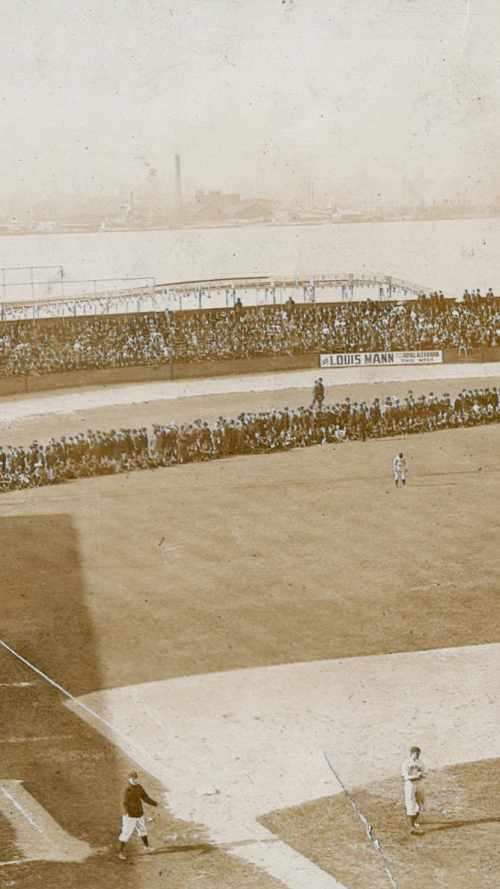 Faded sepia photo of crowd of spectators near shore looking at baseball pitch Faded sepia photo of crowd of spectators near shore looking at baseball pitch