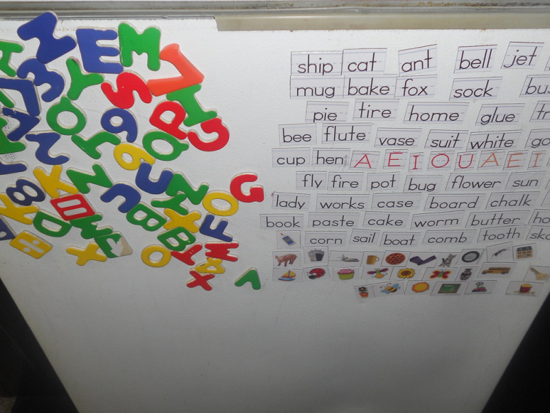 Letter and word magnets on a whiteboard Letter and word magnets on a whiteboard