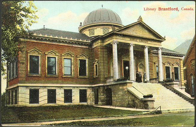 Large two storey library with grand staircase, columns and dome. 