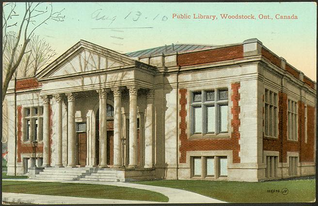 Large brick and stone library building with six pillars. 