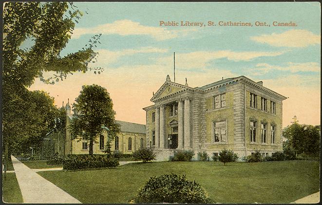 Large two storey stately building in pristine park as shown in vintage postcard
