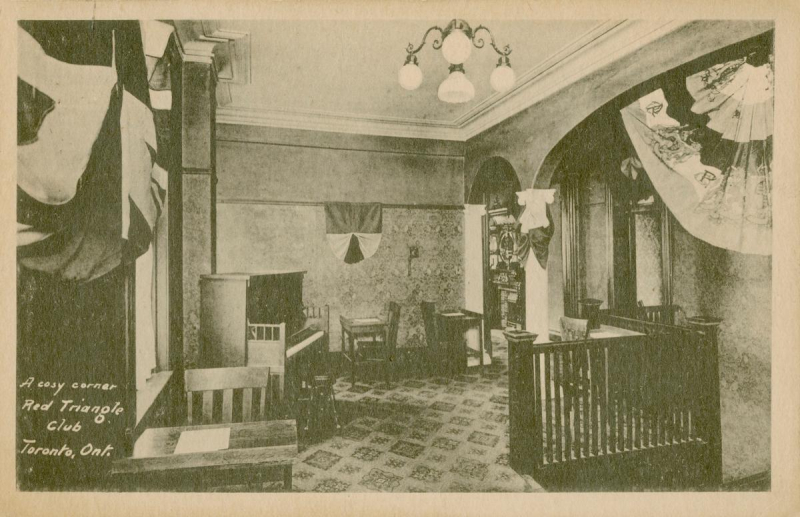 Vintage postcard reading A Cosy corner of Red Triangle Club Toronto Ontario showing an ornate room with piano flags and chairs and tables