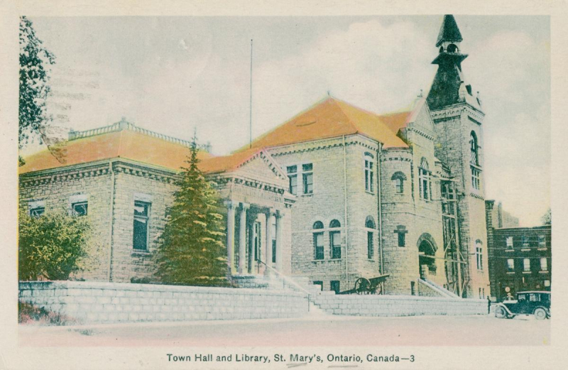 Vintage postcard of two stone buildings with orange roofs and one with bell tower