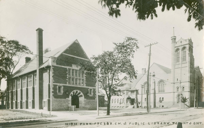 Black and white postcard with brick library in front of church