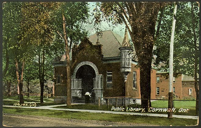 Vintage postcard showing brick building with narrow turret jutting up and a large arched entry