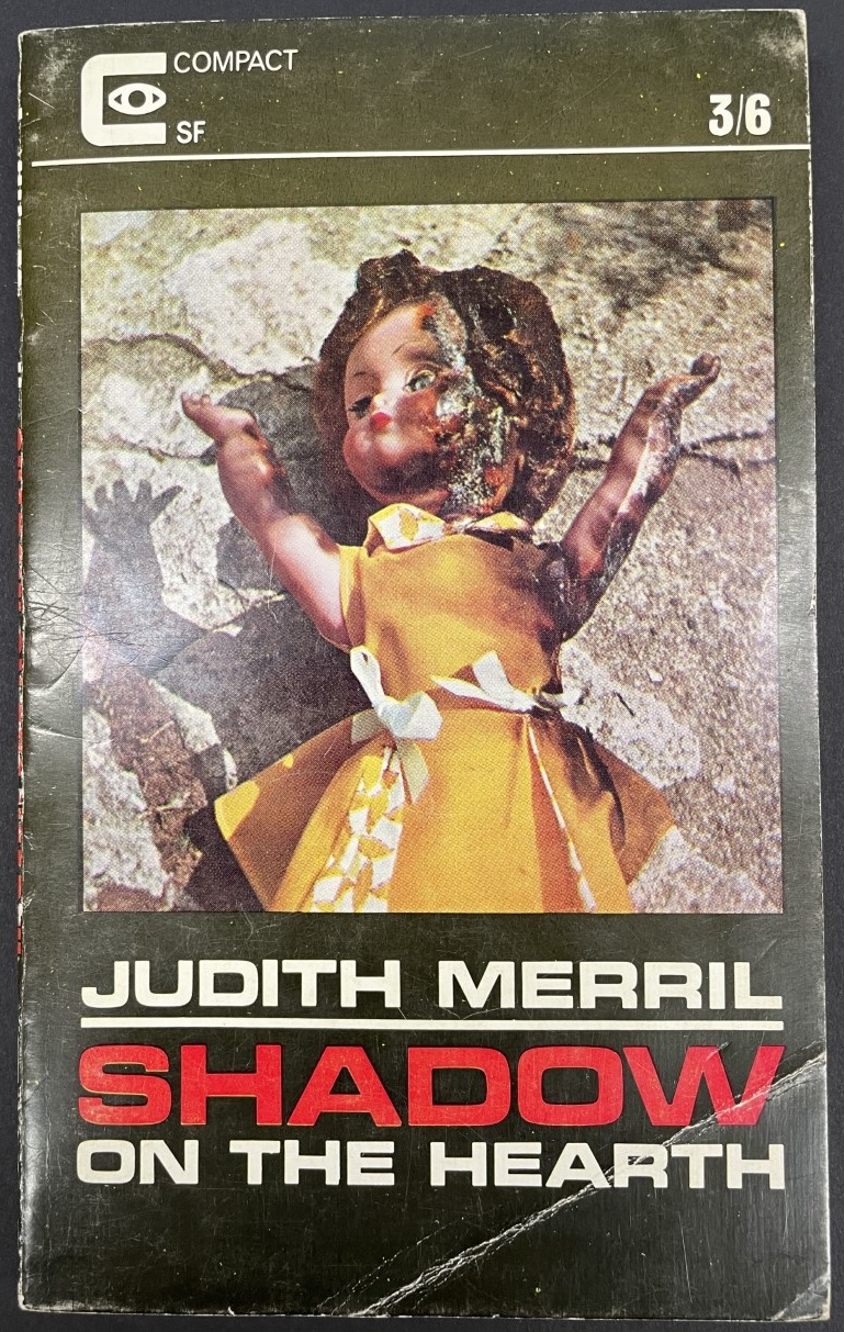 Shadow on the Hearth revised edition. A black cover with white and red text. A plastic doll in a yellow dress with a partially melted face lies on the ground.