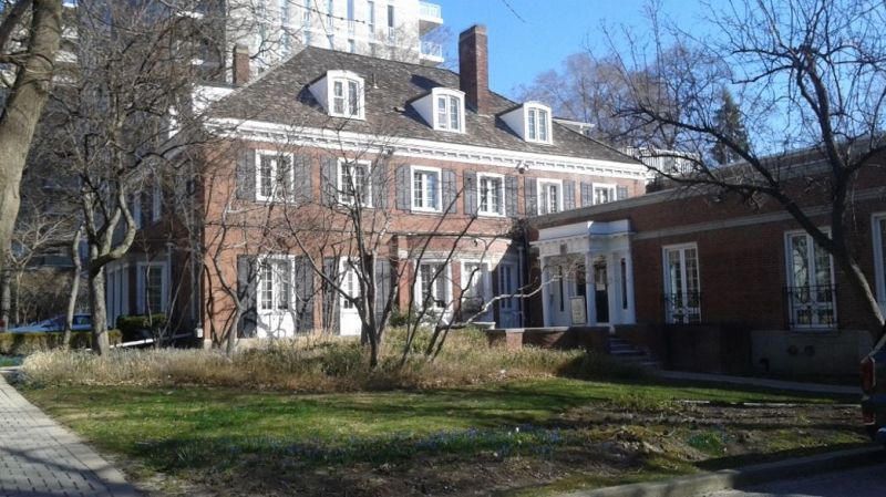Colour photo of two storey building with extension at ground level