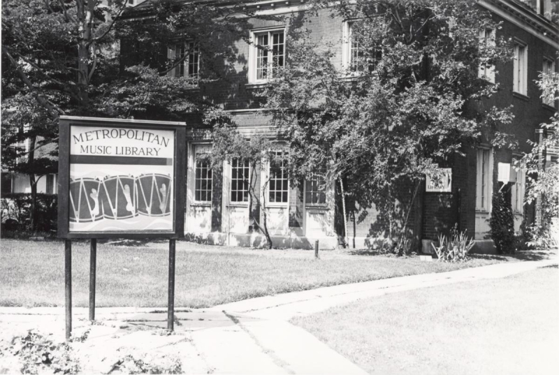 Building covered in leaves and sign reading Metropolitan Music Library