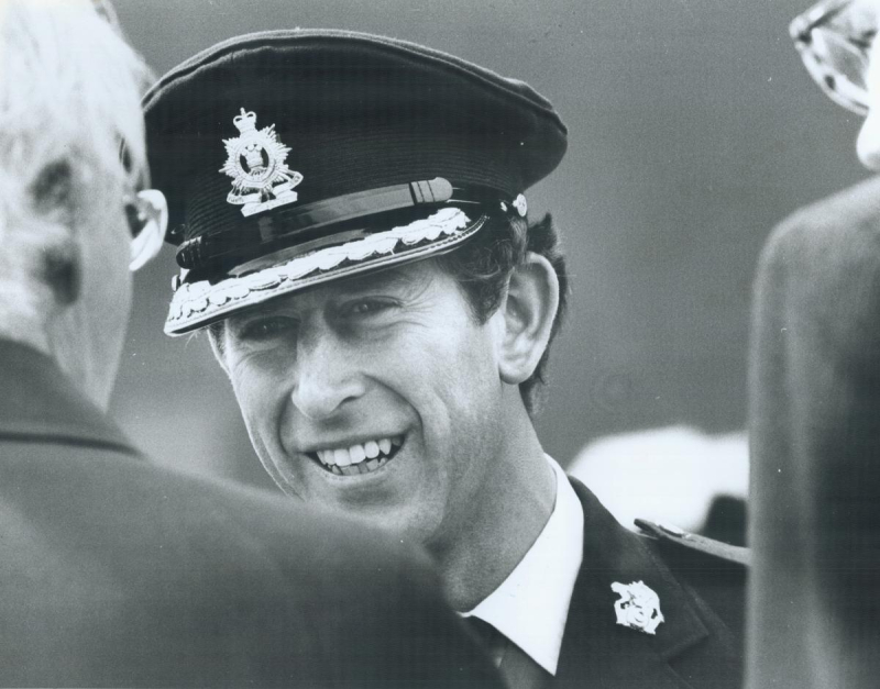 Prince Charles smiling in military cap