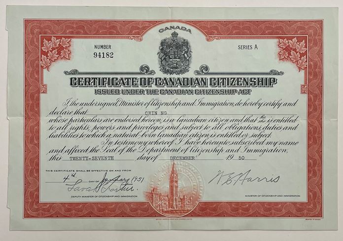 Government record folded and with a red frame and title reading Certificate of Canadian Citizenship Issued under the Canadian Citizenship Act