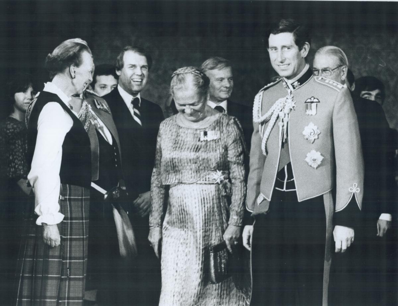 Prince Charles poses in formal military attire alongside others in formal attire