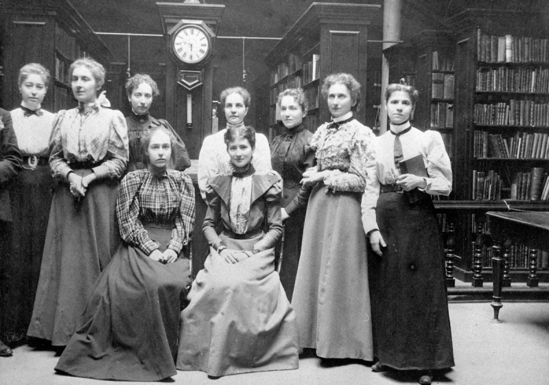 Vintage photo of many woman standing inside old library