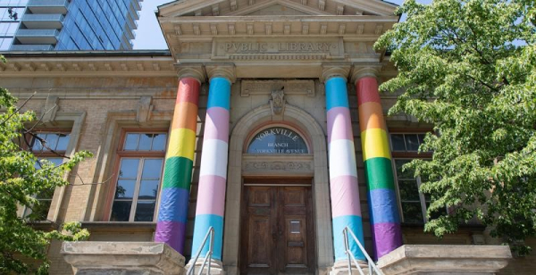 The front of Yorkville branch with the building's large pillars wrapped with pride flags. The front of Yorkville branch with the building's large pillars wrapped with pride flags.