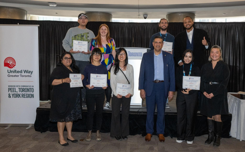Staff gathered around Jag Sharma, holding their award certificates. Staff gathered around Jag Sharma, holding their award certificates.