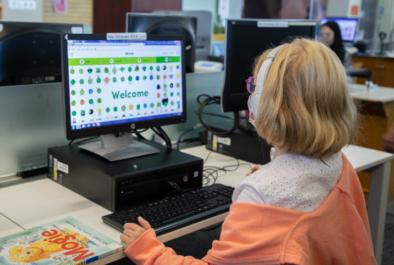 Child using a computer in a library Child using a computer in a library
