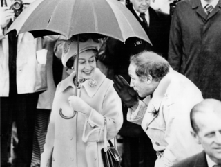 Queen Elizabeth and Prime Minister Pierre Trudeau share an umbrella