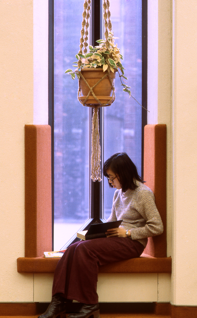Metropolitan Toronto Reference Library window photo of young woman reading 1977. 