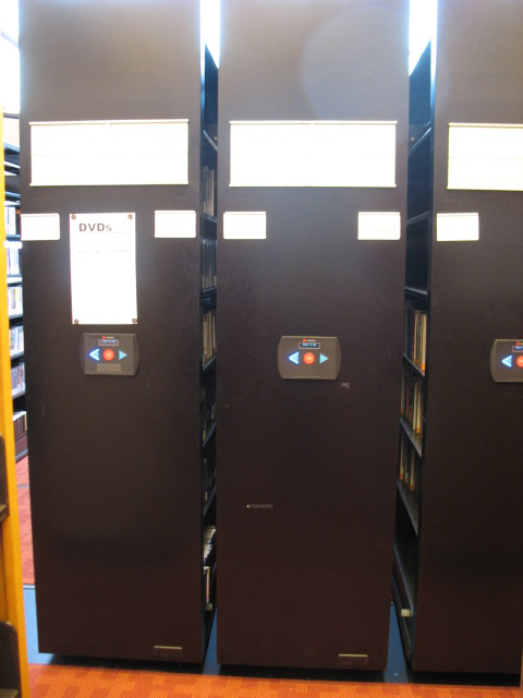 DVD compact shelving of 3 bays seen closed on the 5th floor of the Toronto Reference Library 