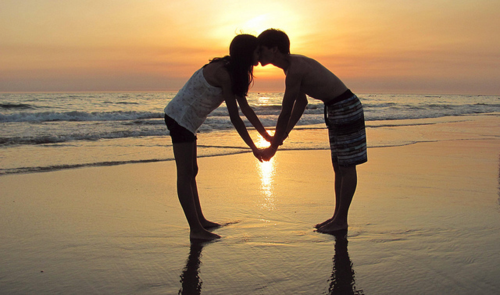 Man and woman kissing on beach