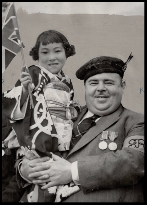 Man holds young girl holding flag Man holds young girl holding flag