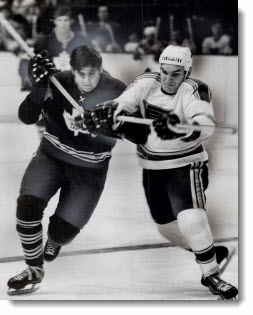 Jim Harrison, Maple Leaf centre, scrambles for puck with Andre Boudrias of St. Louis Blues, 1969
