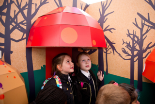 Marta and Angelica listen to recordings of well-known children's stories