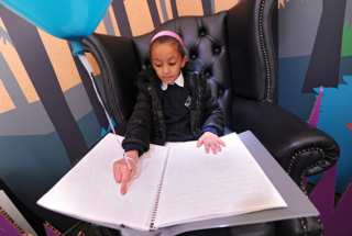 Girl reading Braille Girl reading Braille
