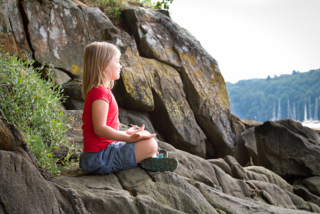 Girl meditating on a rock Girl meditating on a rock
