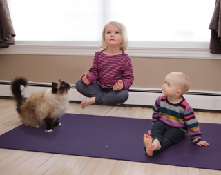 Little girl levitating above a yoga mat Little girl levitating above a yoga mat