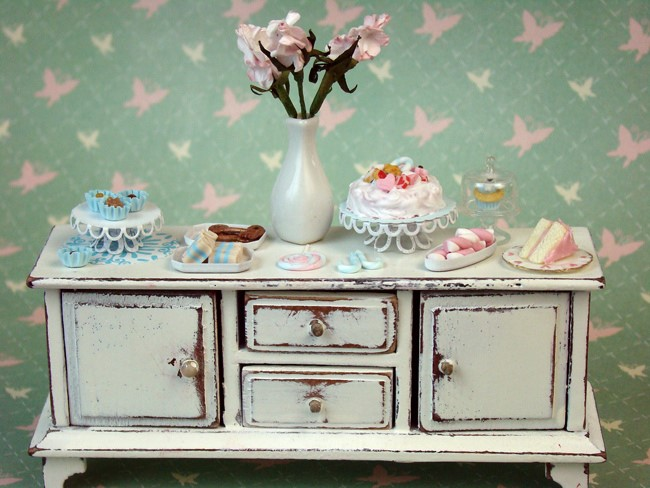 Miniature desserts with a pastel background