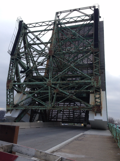 Colour photo of steel lift bridge raised.