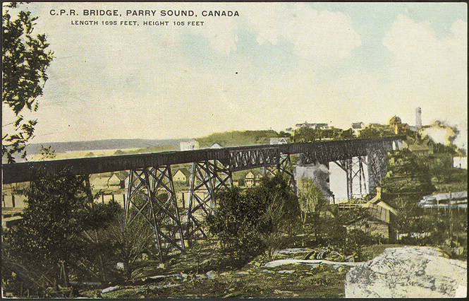 A coloured postcard of a high trestle bridge.