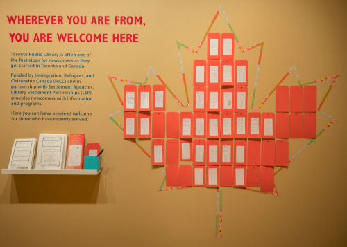 Wall in Destination Canada exhibit with notes of welcome from visitors
