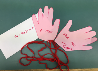 Envelope with "For: My Friend" written on it and the finished sendable hug craft.