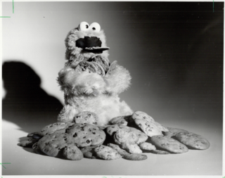 Cookie Monster enjoying some chocolate chip cookies.