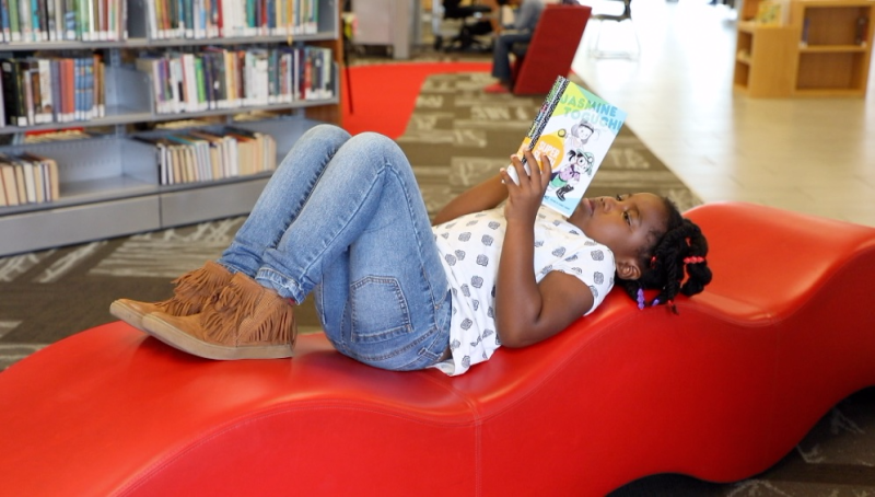 Child reading on bench