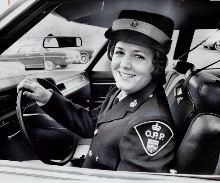 Joan Loftus in uniform in police car