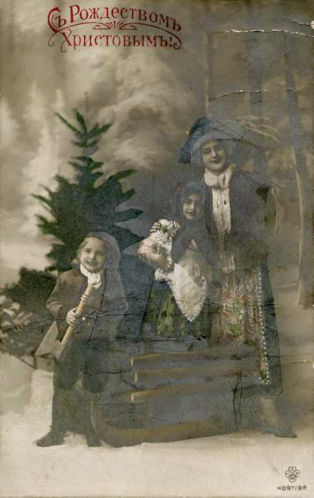 A mother and two children one with an axe standing in front of a tree the black and white photo his been coloured in green in certain places like the dresses and tree A mother and two children one with an axe standing in front of a tree the black and white photo his been coloured in green in certain places like the dresses and tree