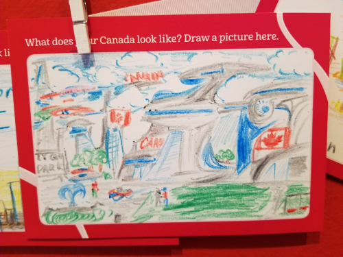 Crayon drawing of a seemingly futuristic city with green parks and lots of clouds and two Canadian flags Crayon drawing of a seemingly futuristic city with green parks and lots of clouds and two Canadian flags