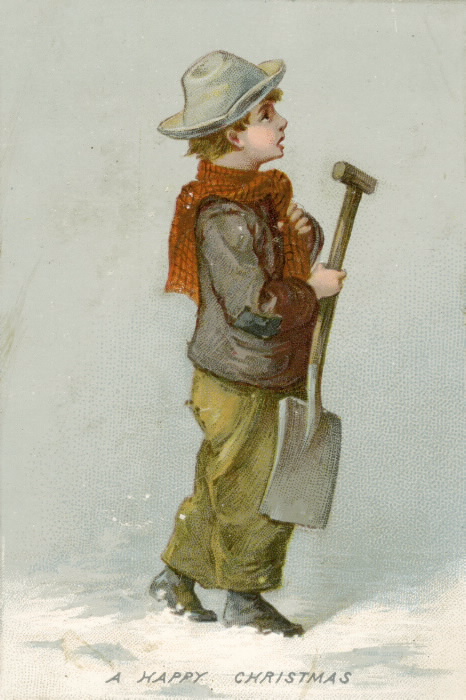 A boy dressed in winter clothes carries a shovel in the snow A boy dressed in winter clothes carries a shovel in the snow