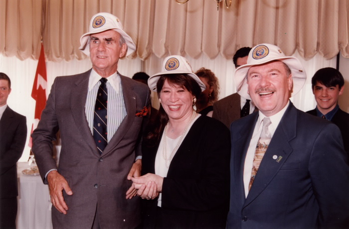 Image of Ethel Blondin-Andrew standing next to two other politicians wearing white hats