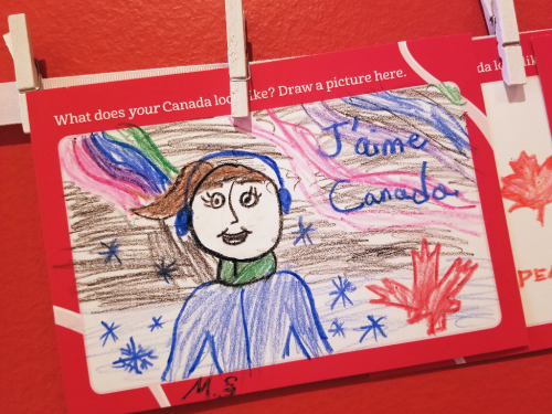 Crayon drawing of a girl with earmuffs in the winter with french that reads J'aime Canada Crayon drawing of a girl with earmuffs in the winter with french that reads J'aime Canada