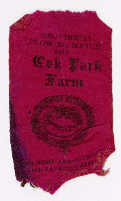 Red ribbon reading Provincial plowing match 1917  Oak Park Farm  For Home and Country  God Save the King