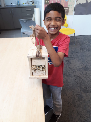 Boy holding solitary bee home;  photo credit Janelle Richards