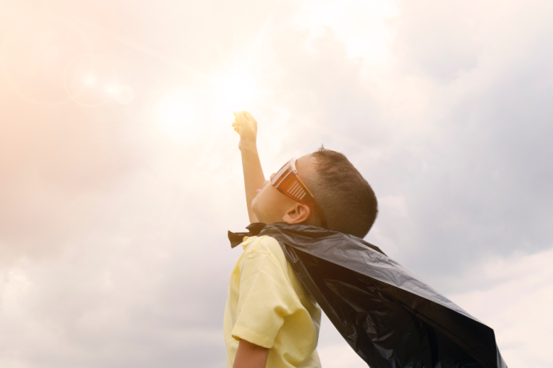 Boy wearing super hero cape