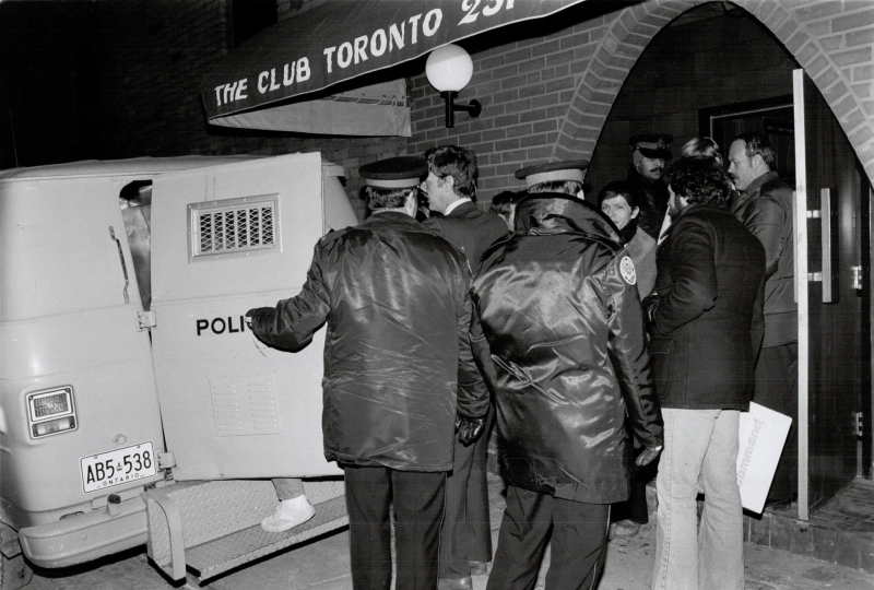 Men being led into a police van after the raid on The Club, 1981