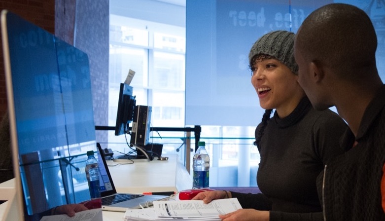 Two people working at a computer