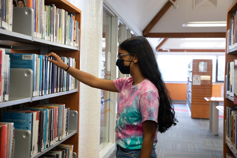 Teen browsing in the library