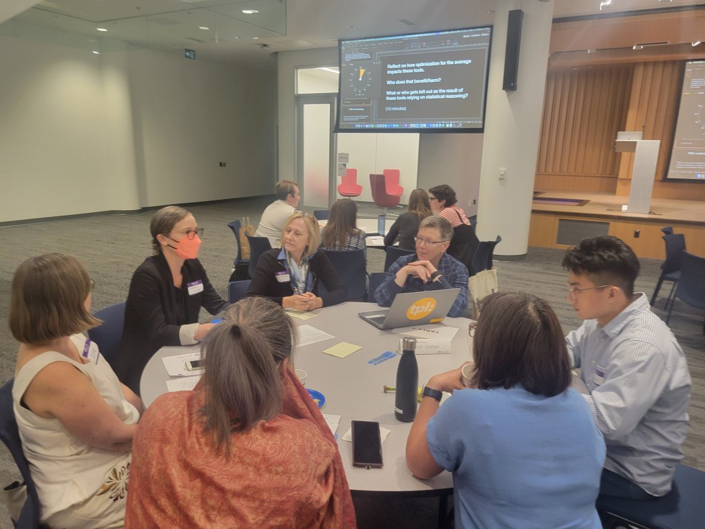 Conference participants, including Dr. Jutta Treviranus, engage in table discussions on the topic of AI and accessibility